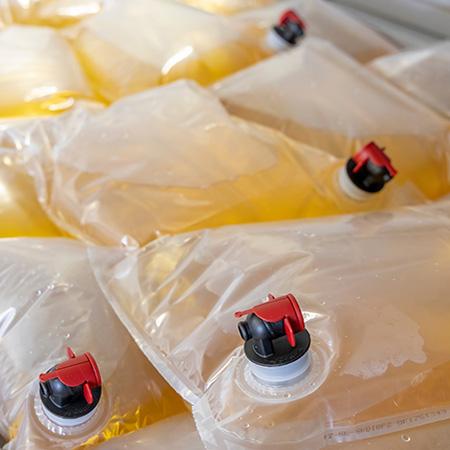 A close up of several bag in box bags filled with cider and beer