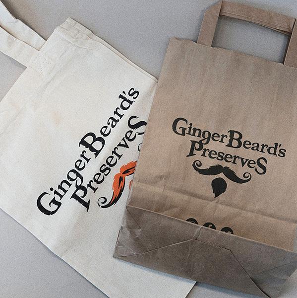 A cotton and Paper bag branded with the logo and name of Gingerbeard's Preserves.