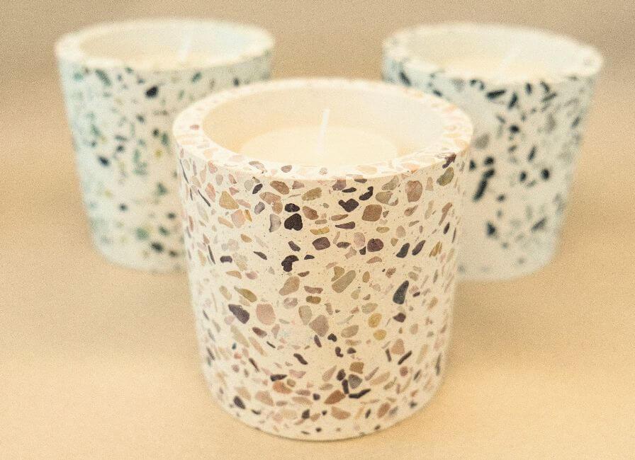 Three Terrazzo Candle Jars, on a brown background.