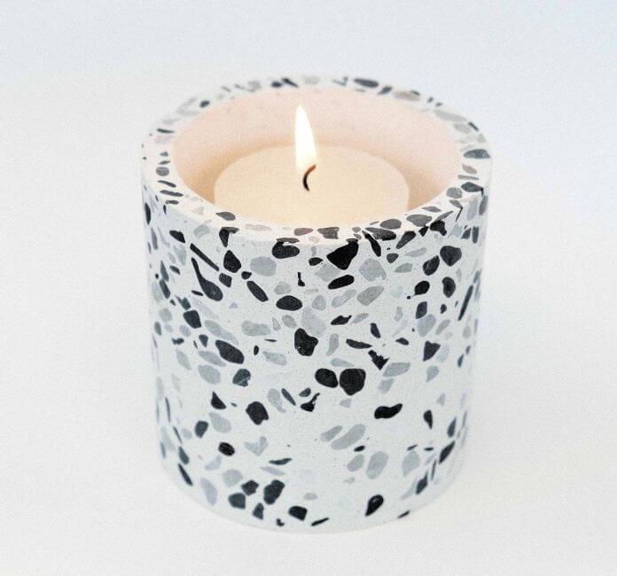 A Black and White Terrazzo Candle, on a white background.