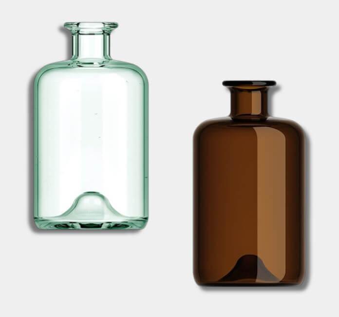 Two glass diffusers, one amber and one clear, on a grey background. 