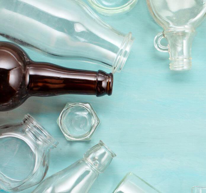 Glass bottles and glass jars on a blue background.