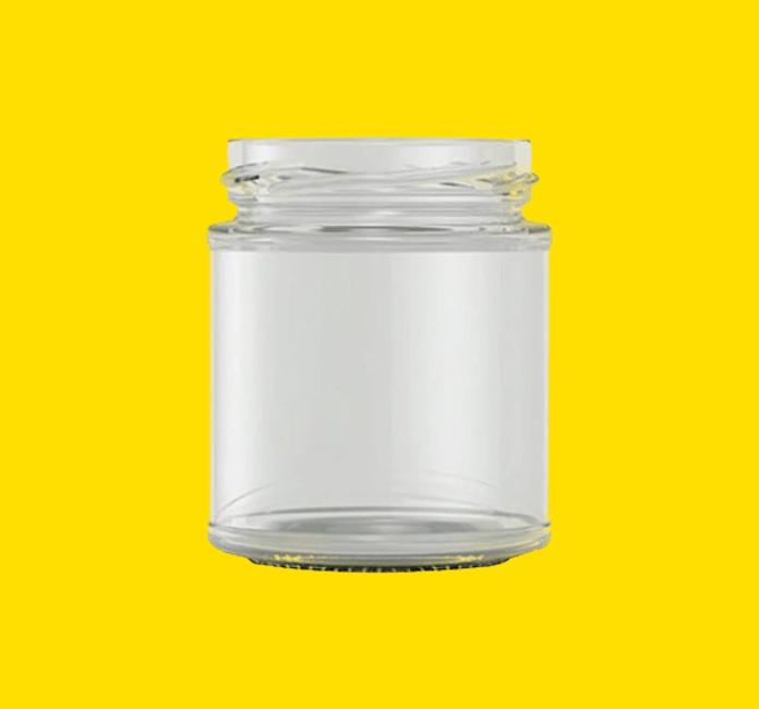 Panelled glass food jar on a yellow background.