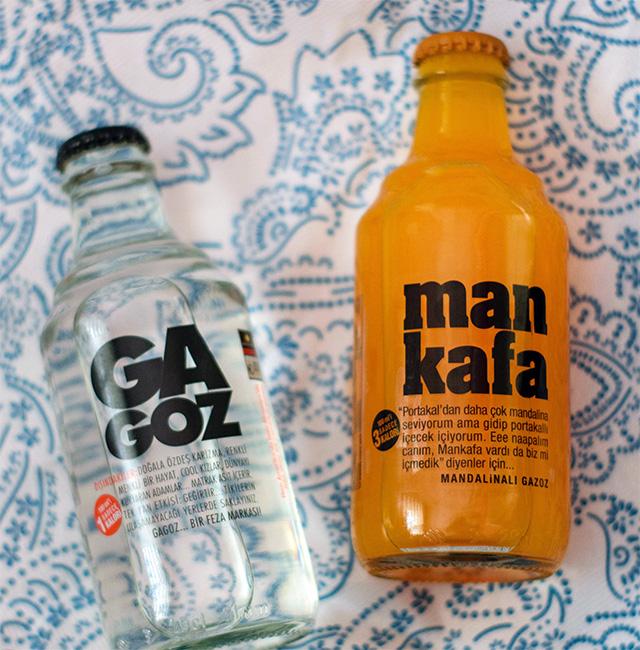 Two glass drinks bottles with screen printing on the surface. 